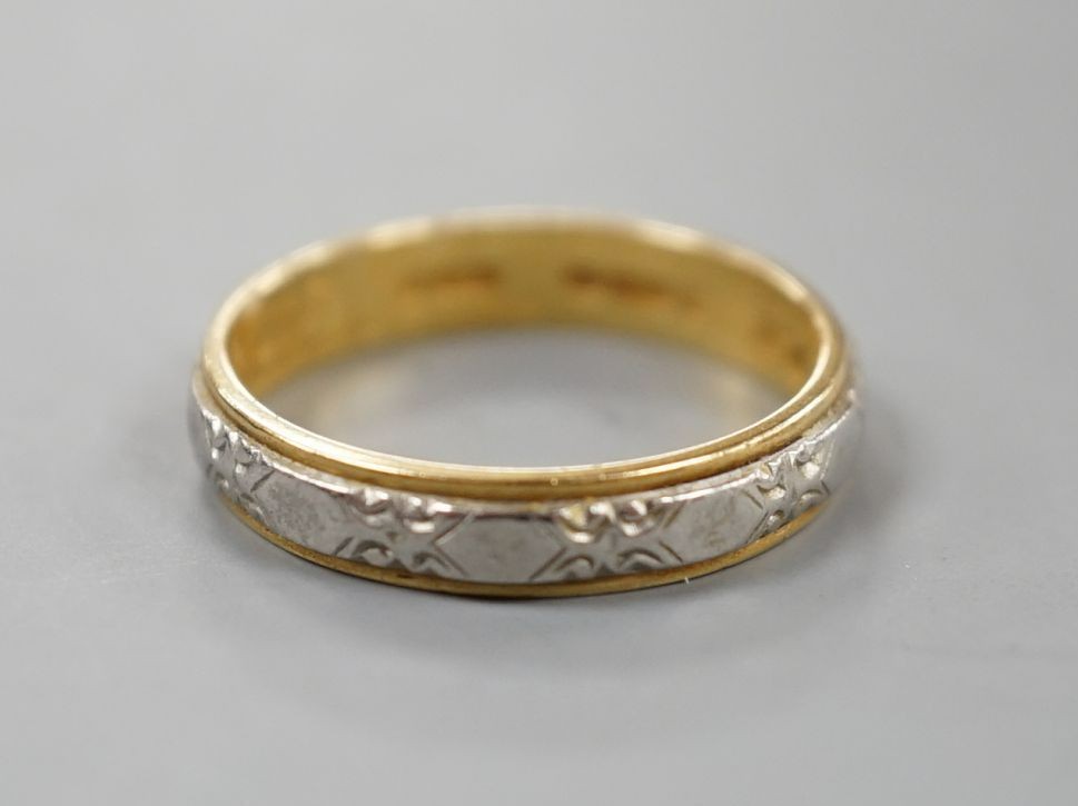 A modern 18ct two colour gold band, size L